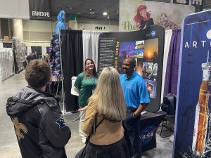 Attendees at the NASA booth on the show floor of Fan Expo New Orleans, January 2025